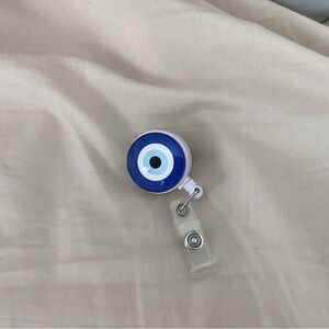 Evil eye badge reel
